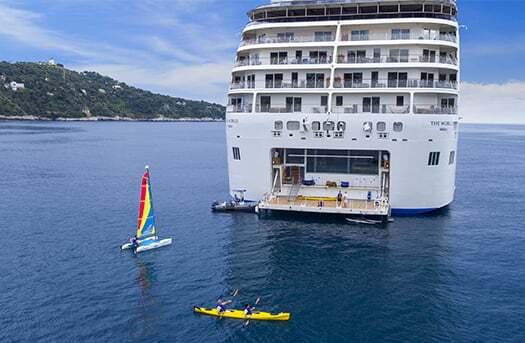 People doing kayak and wind sail around back of cruise ship