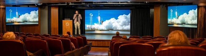 man lecturing on stage