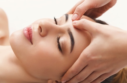 woman receiving skin care on face