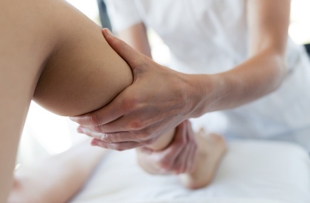woman receiving massage to leg