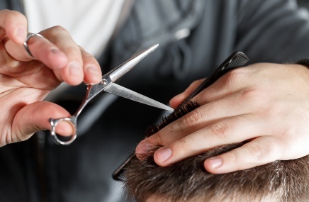 up close shot of barber cutting hair